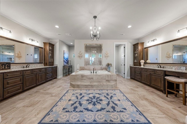 105 Clear Springs Ct, Marble Falls, TX 78654 - full bathroom featuring a bath, two vanities, recessed lighting, and a chandelier