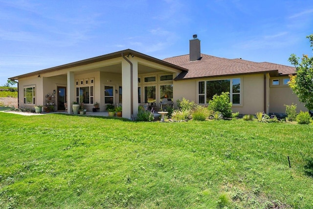 105 Clear Springs Ct, Marble Falls, TX 78654 - back of property featuring a chimney, stucco siding, and a yard