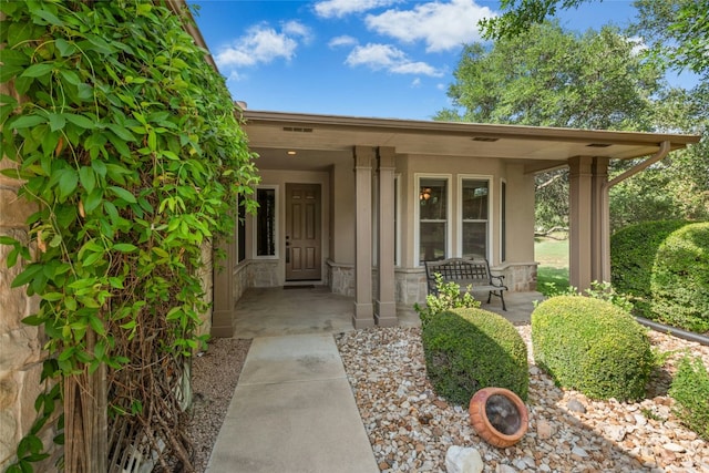 140 Whispering Wind Dr, Georgetown, TX 78633 - property entrance with covered porch and stone siding