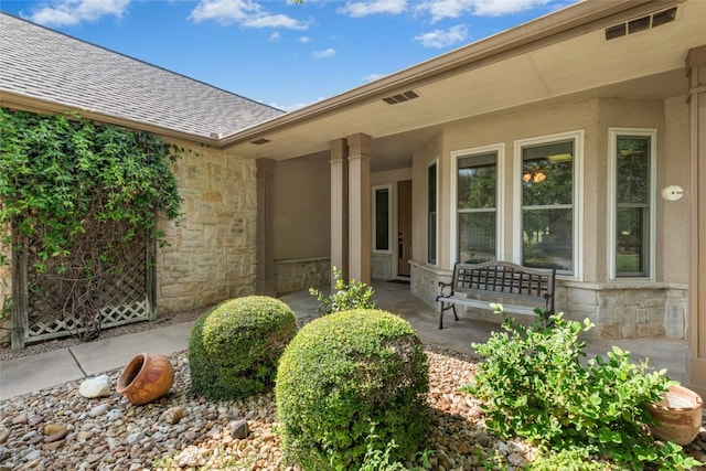 140 Whispering Wind Dr, Georgetown, TX 78633 - view of exterior entry with stone siding and roof with shingles