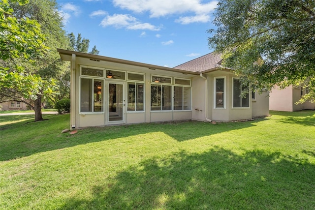 140 Whispering Wind Dr, Georgetown, TX 78633 - back of property with a yard, stucco siding, and a sunroom