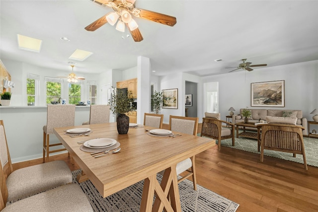 140 Whispering Wind Dr, Georgetown, TX 78633 - dining room featuring ceiling fan, light wood-type flooring, a skylight, and recessed lighting