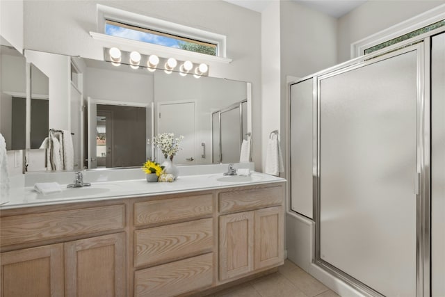 140 Whispering Wind Dr, Georgetown, TX 78633 - bathroom featuring a shower stall, double vanity, and tile patterned floors