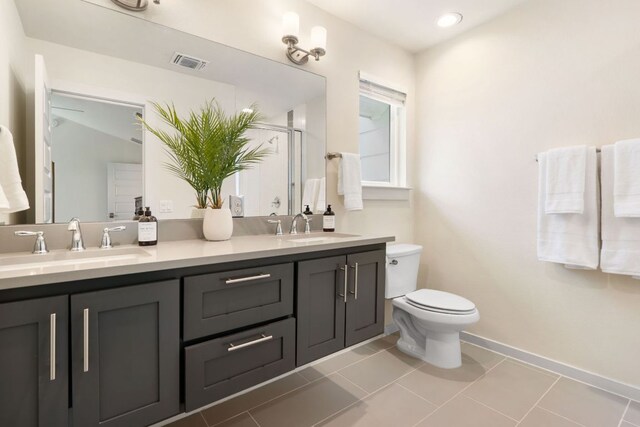 6204 Hickman Ave Unit A, Austin, TX 78723 - bathroom with double vanity, a shower with door, and tile patterned floors