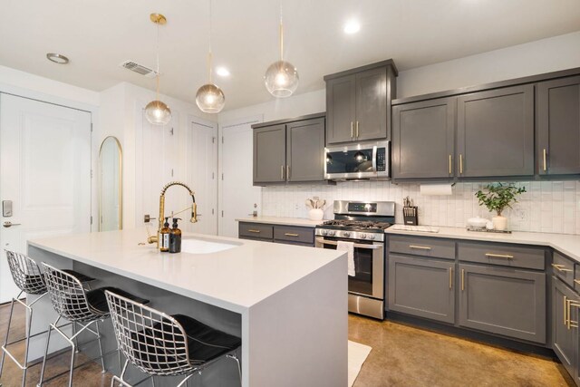 6204 Hickman Ave Unit A, Austin, TX 78723 - kitchen featuring stainless steel appliances, backsplash, finished concrete floors, gray cabinetry, and light countertops