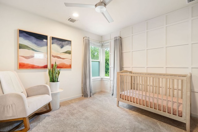 6204 Hickman Ave Unit A, Austin, TX 78723 - bedroom featuring carpet flooring, a crib, a decorative wall, and a ceiling fan