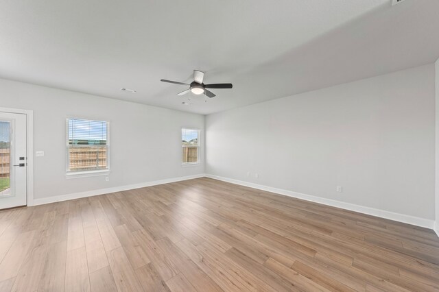 9509 Demure Dr Unit 5, Manor, TX 78653 - empty room with a ceiling fan, healthy amount of natural light, and light wood finished floors
