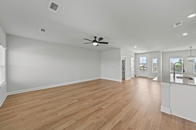 9509 Demure Dr Unit 5, Manor, TX 78653 - unfurnished living room with ceiling fan, recessed lighting, and light wood-type flooring