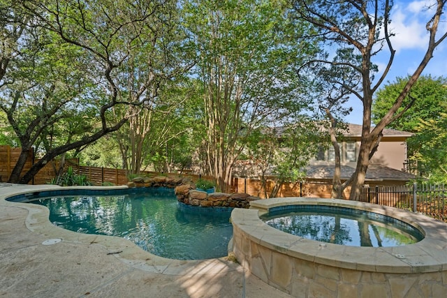 7709 Waldon Dr, Austin, TX 78750 - view of swimming pool with an in-ground hot tub and a fenced backyard