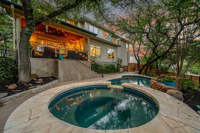 7709 Waldon Dr, Austin, TX 78750 - pool at dusk featuring stairs and a pool with connected hot tub