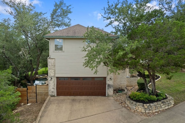 7709 Waldon Dr, Austin, TX 78750 - view of front of house featuring concrete driveway, a garage, and roof with shingles
