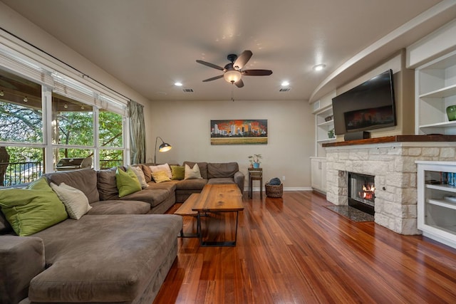 7709 Waldon Dr, Austin, TX 78750 - living room featuring wood finished floors, ceiling fan, a fireplace, recessed lighting, and built in features