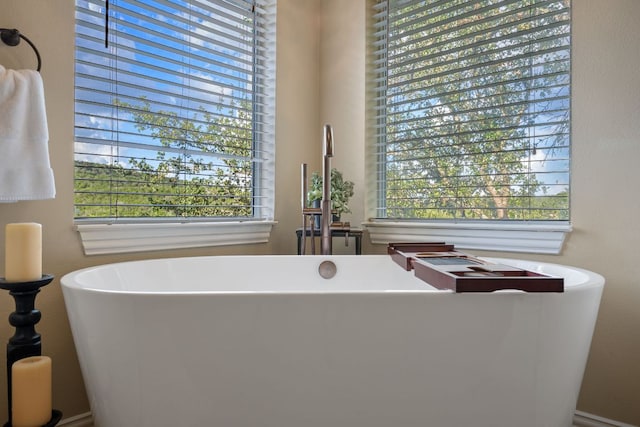 7709 Waldon Dr, Austin, TX 78750 - bathroom featuring plenty of natural light and a freestanding tub