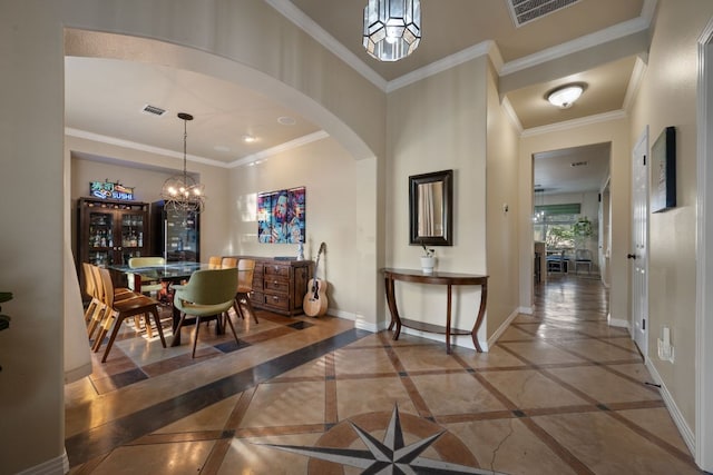 7709 Waldon Dr, Austin, TX 78750 - hallway with arched walkways, a chandelier, and ornamental molding