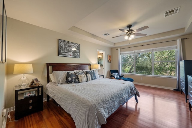 7709 Waldon Dr, Austin, TX 78750 - bedroom featuring a raised ceiling, wood finished floors, and ceiling fan