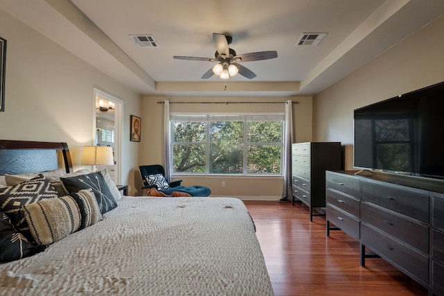7709 Waldon Dr, Austin, TX 78750 - bedroom with a raised ceiling, wood finished floors, and ceiling fan