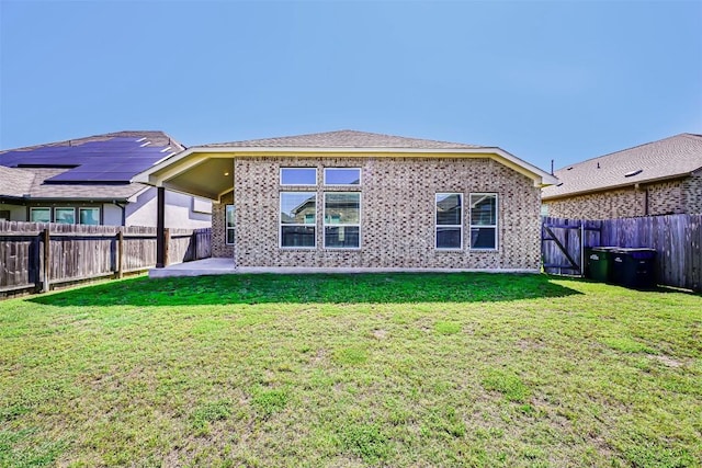 1017 Sundrops St, Leander, TX 78641 - rear view of property featuring a fenced backyard, a patio area, and brick siding
