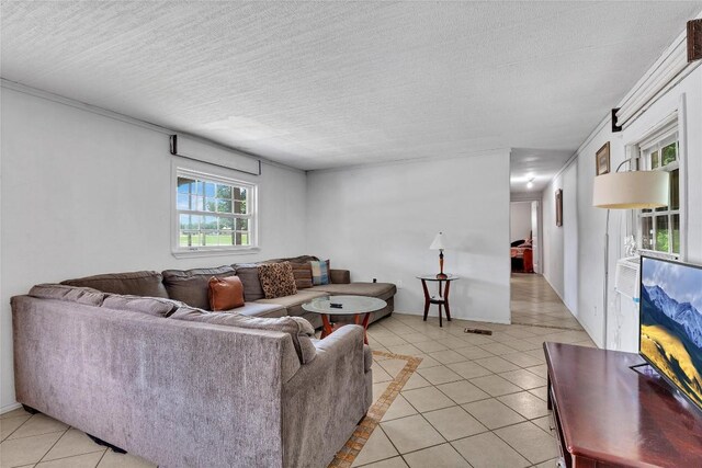 101 E Ash St, Granger, TX 76530 - living area featuring light tile patterned flooring and a textured ceiling