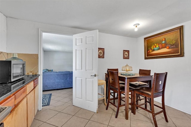 101 E Ash St, Granger, TX 76530 - dining room with light tile patterned floors and a wood stove