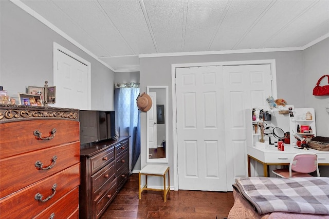 101 E Ash St, Granger, TX 76530 - bedroom with ornamental molding, an office area, dark wood finished floors, and a closet