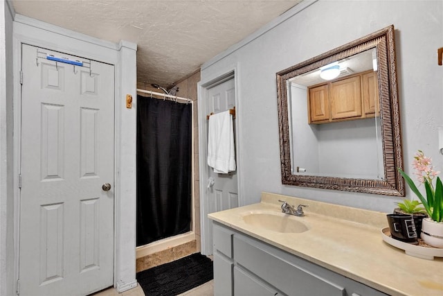 101 E Ash St, Granger, TX 76530 - bathroom featuring vanity, a textured ceiling, a shower stall, and tile patterned floors