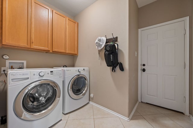 1012 Autumn Sage Way, Pflugerville, TX 78660 - laundry area with cabinet space, light tile patterned floors, and washing machine and clothes dryer