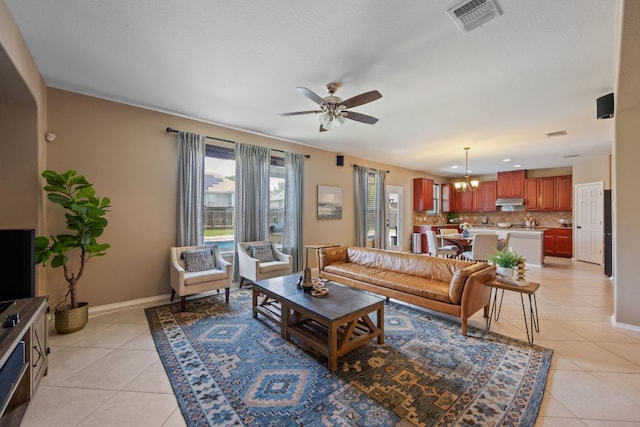 1012 Autumn Sage Way, Pflugerville, TX 78660 - living area with light tile patterned floors, a ceiling fan, and a chandelier