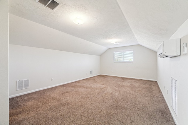 2502 Grey Kirby Dr, League City, TX 77573 - additional living space with light colored carpet, a textured ceiling, a wall mounted AC, and lofted ceiling