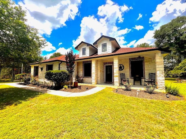 106 Hobbs Creek Cv, Cedar Creek, TX 78612 - view of front of property featuring stone siding, a porch, and a front yard