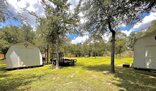 106 Hobbs Creek Cv, Cedar Creek, TX 78612 - view of grassy yard with a storage shed and view of scattered trees