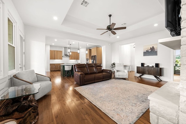 104 Huerta Rd, Florence, TX 76527 - living room with ceiling fan, hardwood / wood-style flooring, recessed lighting, and a tray ceiling