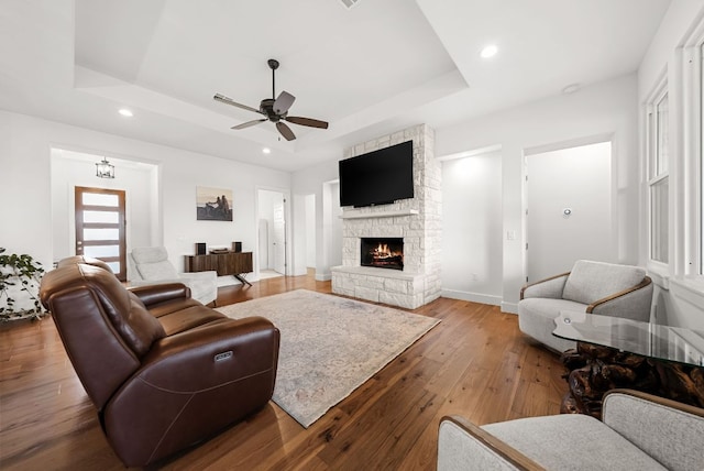 104 Huerta Rd, Florence, TX 76527 - living room with a raised ceiling, hardwood / wood-style flooring, a fireplace, recessed lighting, and ceiling fan