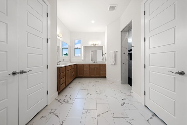 104 Huerta Rd, Florence, TX 76527 - bathroom featuring double vanity, marble finish flooring, and recessed lighting