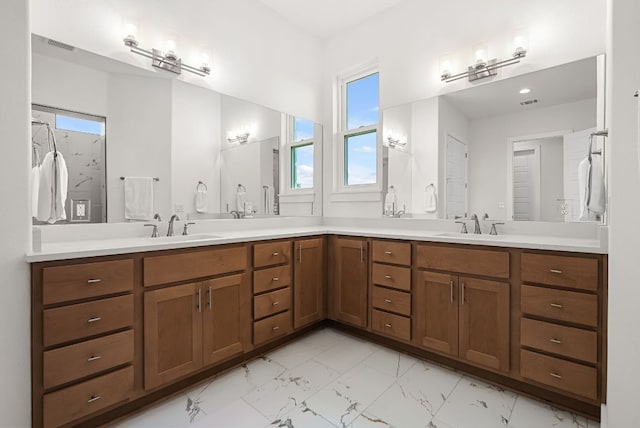 104 Huerta Rd, Florence, TX 76527 - full bathroom with double vanity and marble look tiles