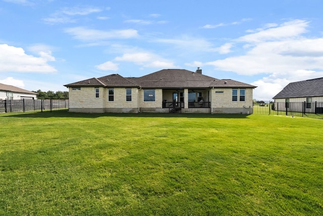 104 Huerta Rd, Florence, TX 76527 - rear view of property with a fenced backyard, stone siding, and a ceiling fan