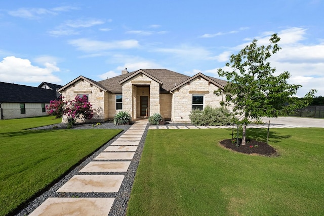 104 Huerta Rd, Florence, TX 76527 - view of front of house with stone siding, a front lawn, and a shingled roof