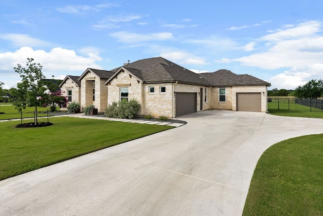 104 Huerta Rd, Florence, TX 76527 - view of front of home with stone siding, a garage, driveway, and a shingled roof