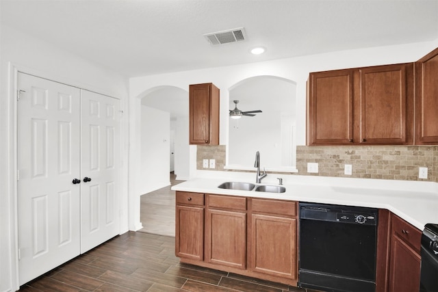 13124 Winecup Mallow Trl, Elgin, TX 78621 - kitchen featuring dishwasher, arched walkways, decorative backsplash, light countertops, and dark wood finished floors