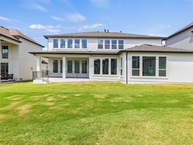 2308 Mondello Path, Leander, TX 78641 - rear view of property with a lawn, a shingled roof, and stucco siding