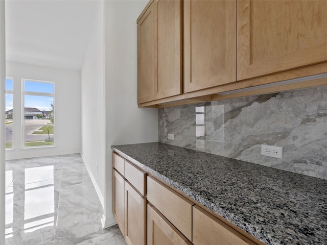 2308 Mondello Path, Leander, TX 78641 - kitchen with light marble finish flooring, backsplash, dark stone countertops, and light brown cabinets