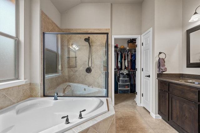 204 Archipelago Trl, Austin, TX 78717 - bathroom with vanity, a garden tub, a stall shower, a spacious closet, and lofted ceiling