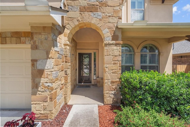 204 Archipelago Trl, Austin, TX 78717 - doorway to property with stone siding, a garage, and stucco siding