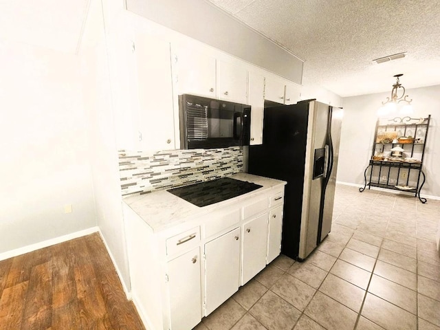 917 Edwards St S, Copperas Cove, TX 76522 - kitchen featuring tasteful backsplash, black appliances, light countertops, white cabinetry, and a textured ceiling