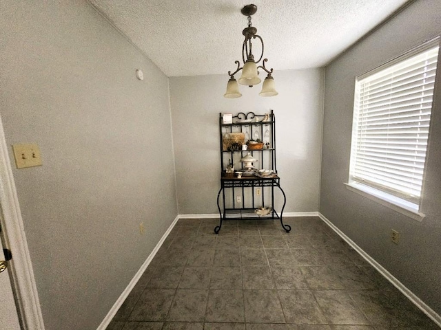 917 Edwards St S, Copperas Cove, TX 76522 - dining area with a textured ceiling, a chandelier, and dark tile patterned floors