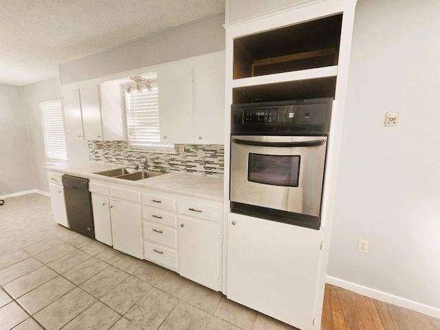 917 Edwards St S, Copperas Cove, TX 76522 - kitchen with stainless steel oven, backsplash, light countertops, white cabinets, and dishwasher