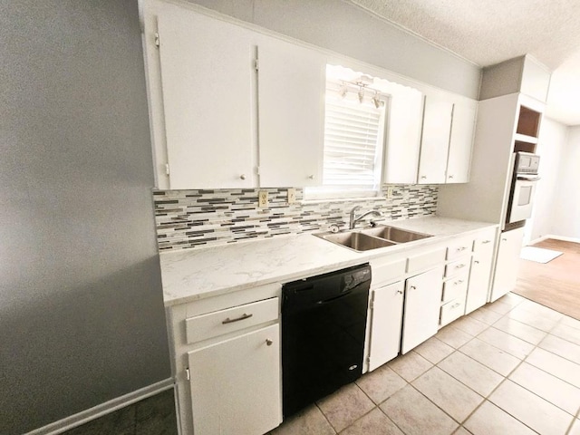 917 Edwards St S, Copperas Cove, TX 76522 - kitchen with light countertops, decorative backsplash, dishwasher, white cabinetry, and a textured ceiling