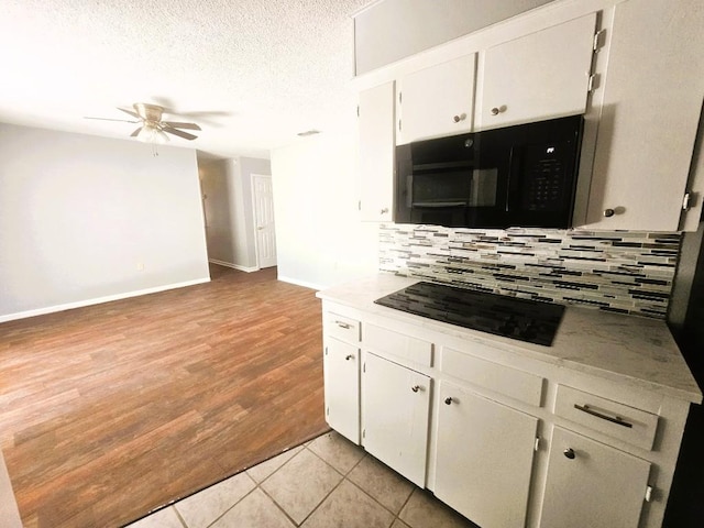 917 Edwards St S, Copperas Cove, TX 76522 - kitchen with a ceiling fan, decorative backsplash, black appliances, white cabinets, and a textured ceiling