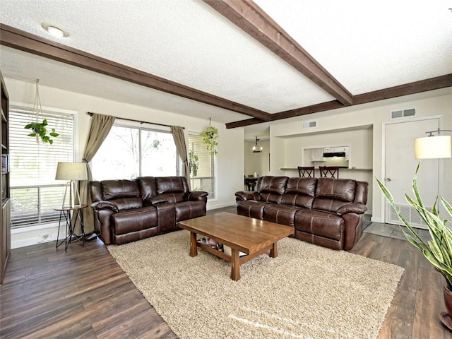 100 Lido Cir Unit A1, Lakeway, TX 78734 - living room with beam ceiling, dark wood-style flooring, and a textured ceiling