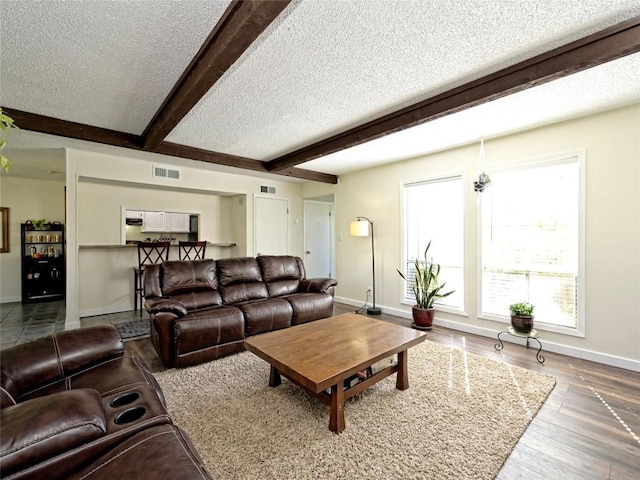 100 Lido Cir Unit A1, Lakeway, TX 78734 - living area featuring a textured ceiling, beamed ceiling, and wood finished floors