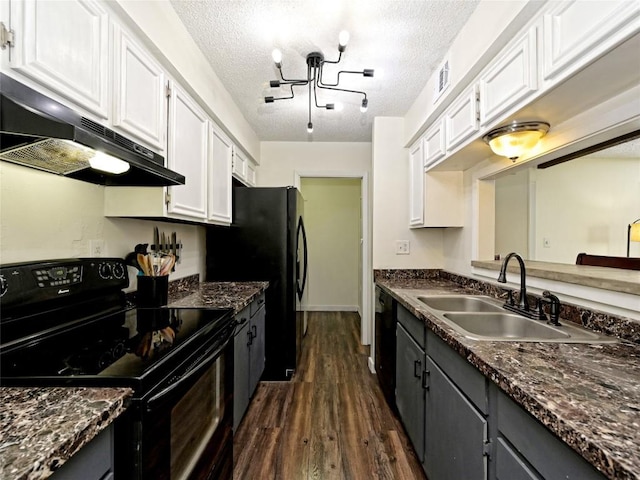 100 Lido Cir Unit A1, Lakeway, TX 78734 - kitchen with black appliances, under cabinet range hood, white cabinetry, dark wood-style flooring, and a textured ceiling
